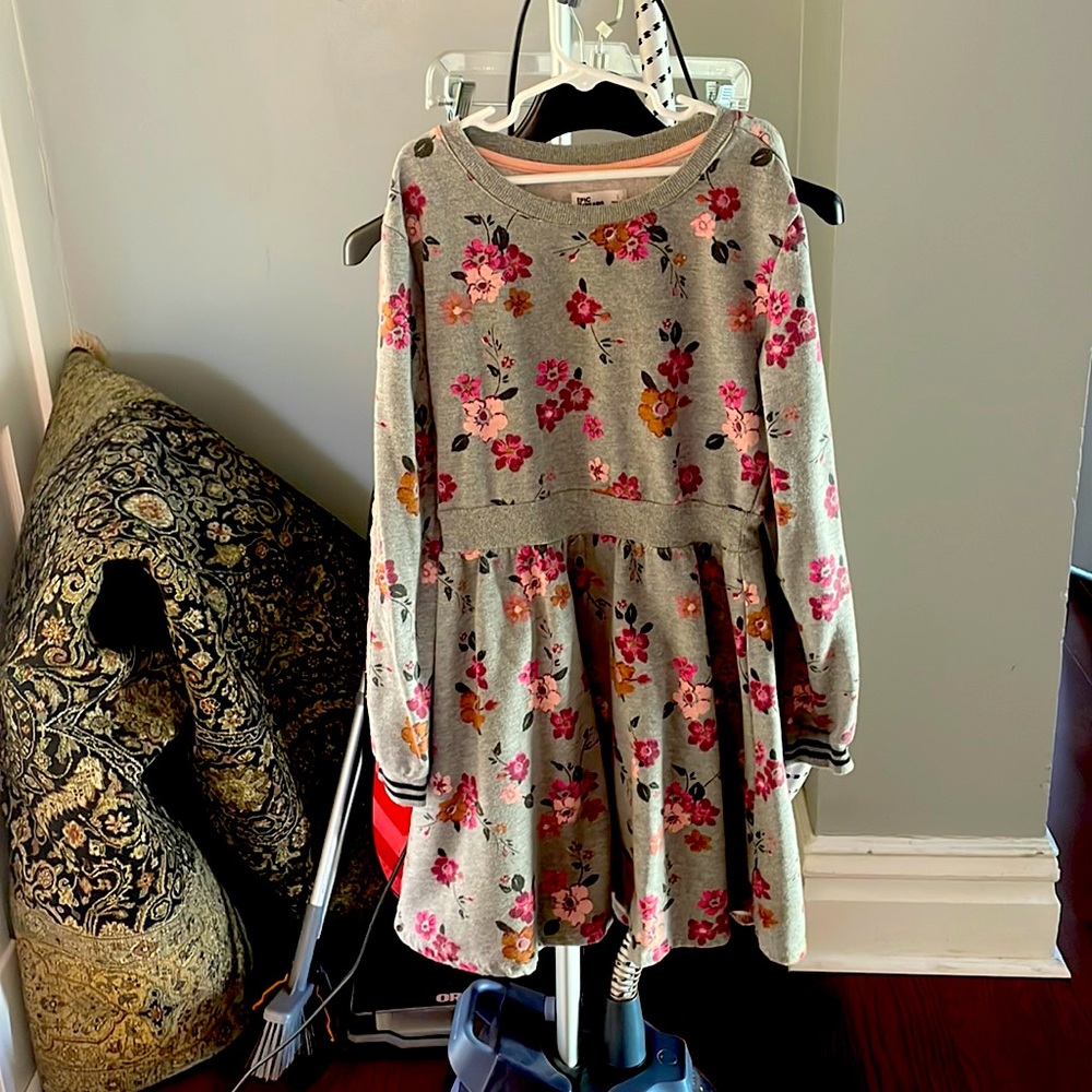 A floral dress with a velvet pattern along side the sleeves